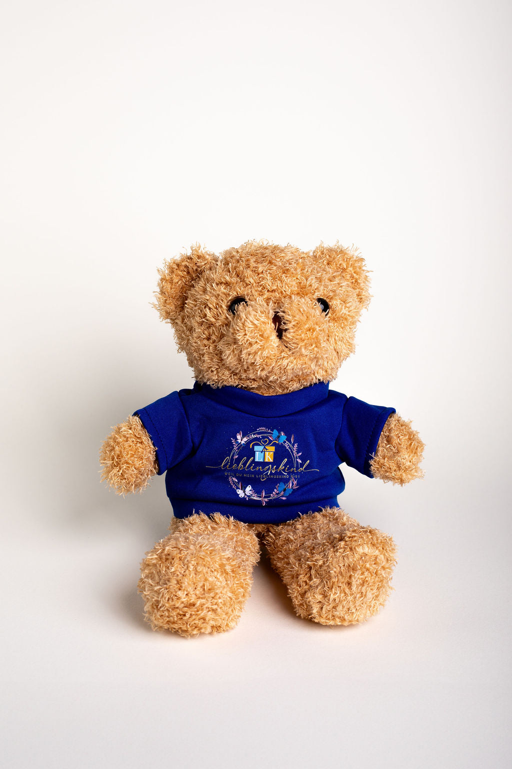 Lieblingskind-Teddybär mit königsblauem Shirt
